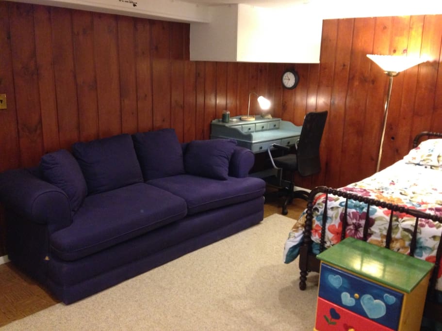 A couch and desk for lounging and studying.