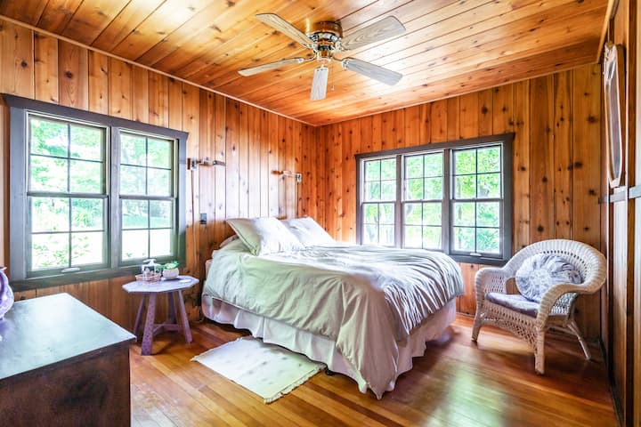 Main floor bedroom with queen bed and lake views