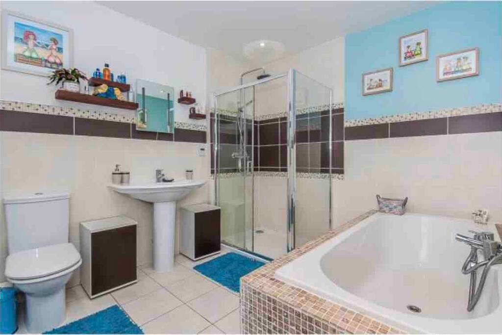 Shared bathroom with four piece suite including very large waterfall shower