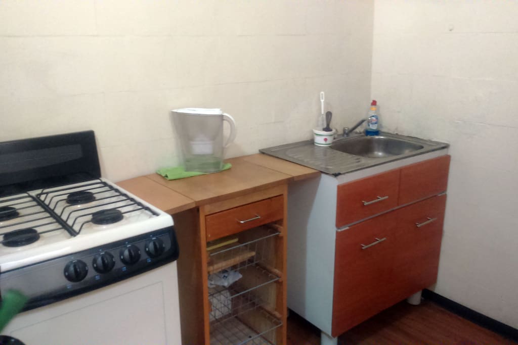 Kitchen with microwave, coffee maker, stove, mini oven and assorted tools