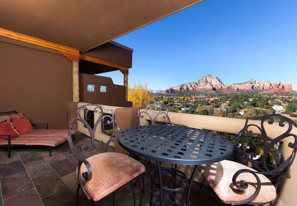 The best panoramic views of Sedona's red rocks right from outside your suite. There is a large chaise lounge as well as dining table and chairs.