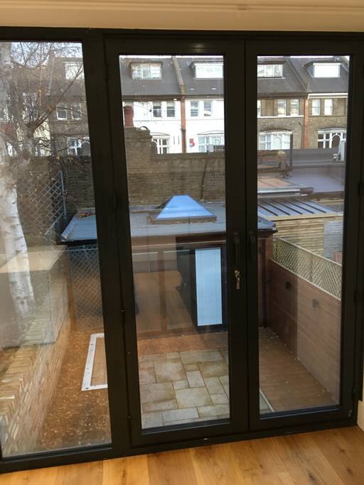 floor-to-ceiling bi-folding window (with good quality blinds) overlooking back garden, opening wide to a Juliet balcony