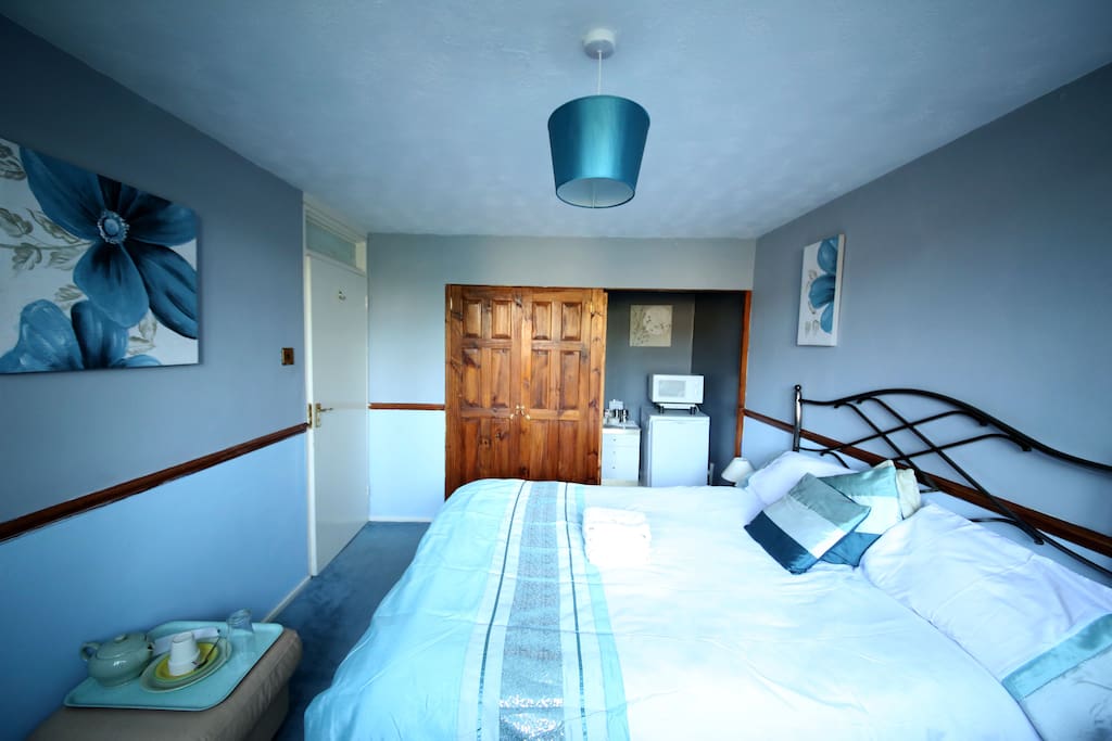 Bedroom complete with wardrobe, fridge, microwave and coffee facilities for a comfortable stay.