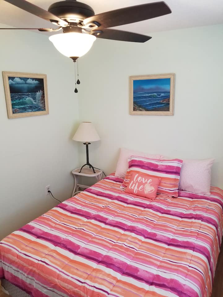 Dormitorio 2 con cama tamaño queen. También cuenta con una televisión inteligente LED montada en la pared