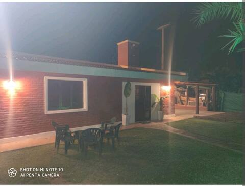 House with  patio, barbecue and garage.