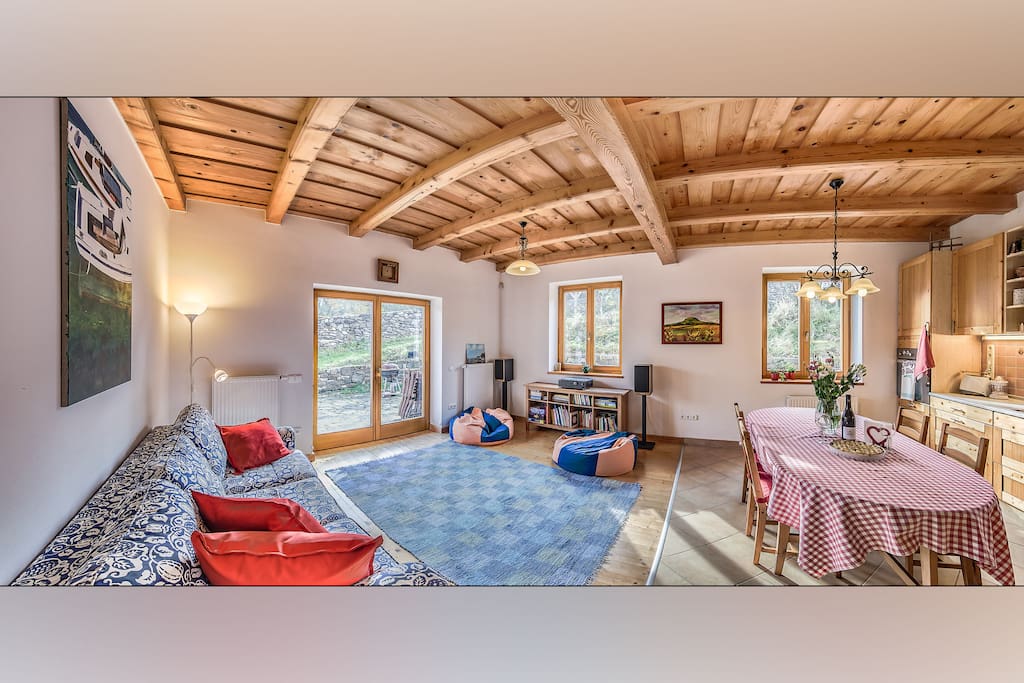Our lovely living room / kitchen where stuff happens. This space is directly connected to the terrace, so your living room extends to the open. The terrace has tables and chairs, and obviously a barbeque! You can cook goulash in the garden as well.