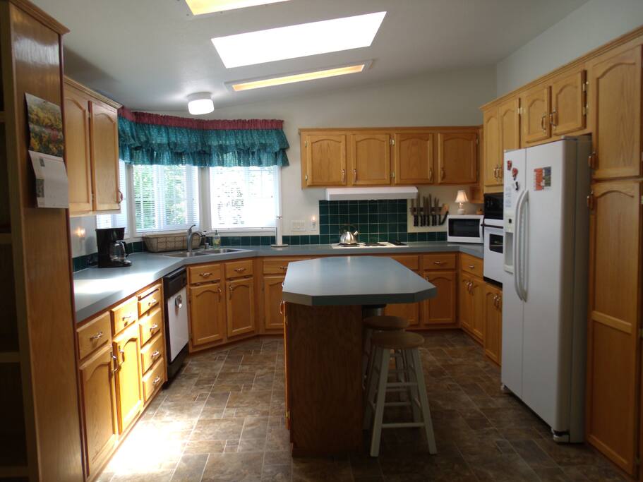 Sunny, Airy Kitchen with Breakfast Bar seating.