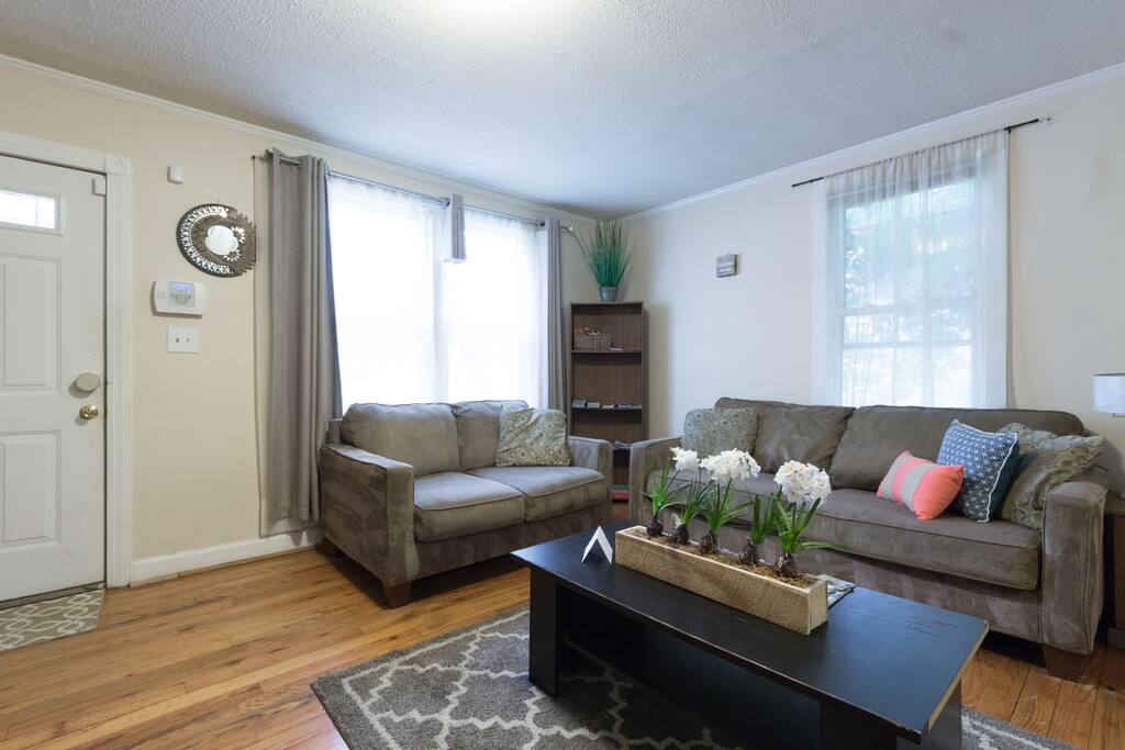 Living room couch and love seat. Bookcase with brochures and board games for your enjoyment.