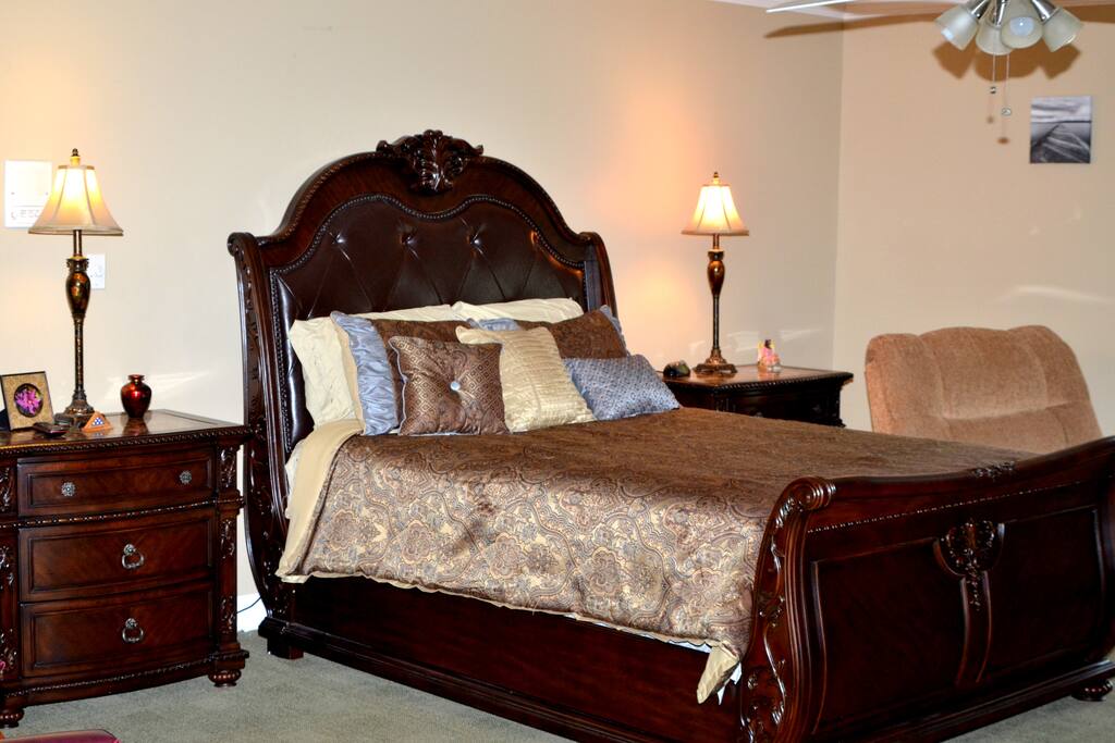 Large En-Suite with queen bed, desk, 42-in TV, reading nook, and refrigerator