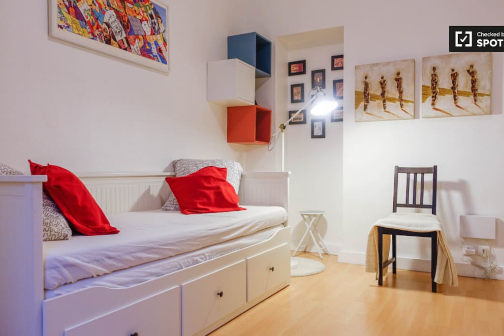 Comfortable main room with double bed, cupboard, dining table and shelf.