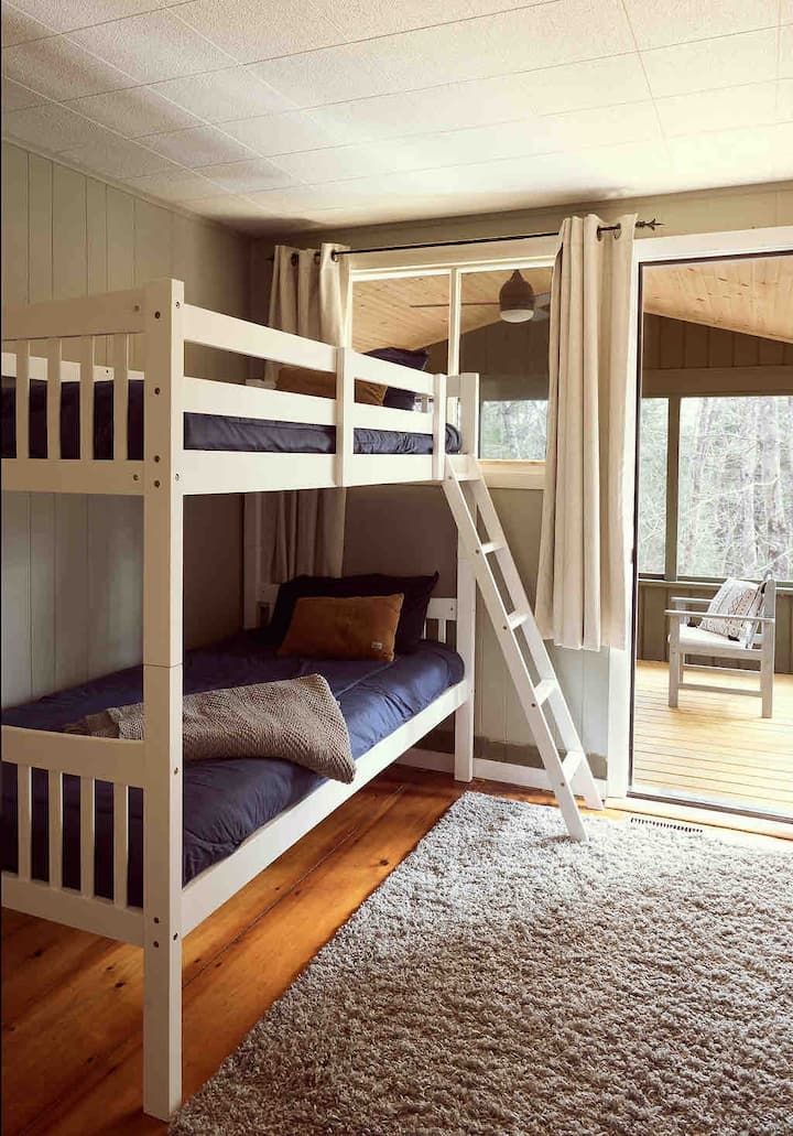 Bedroom 3 with bunk beds and door to the screened-in porch