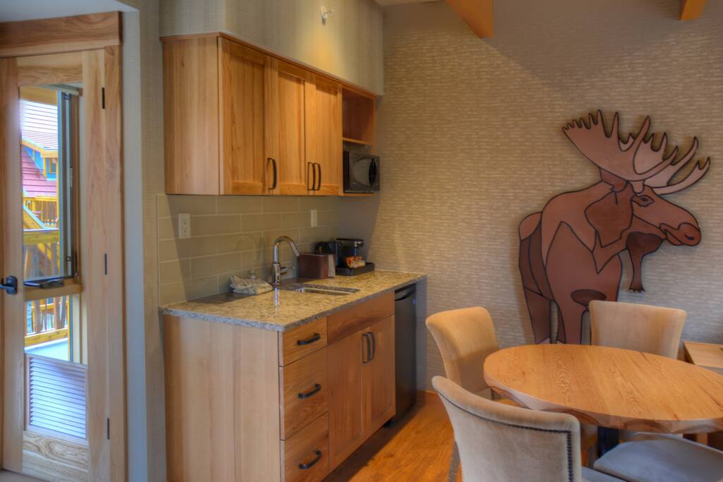 Prepare a meal in the equipped kitchen nook with mini-fridge, microwave and sink.