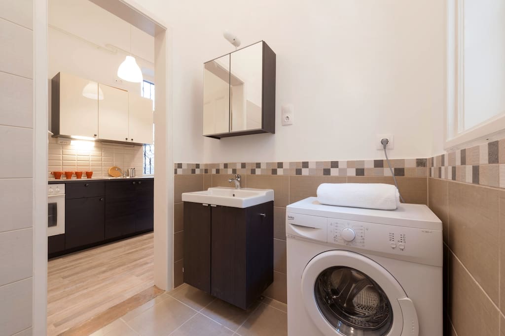The bathroom, kitchen in the background.
