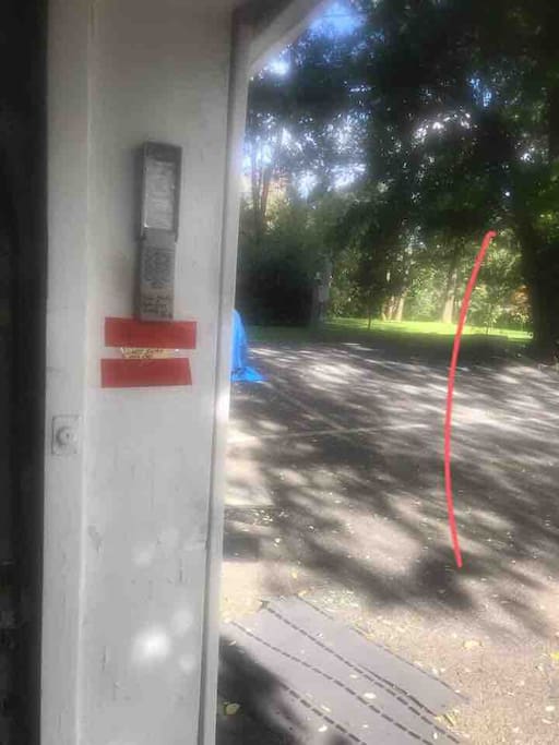 Keypad for self checking with two red strips underneath it as you come up the driveway the first garage on the left ,
parking spot is number two or three next to the blue covered car.