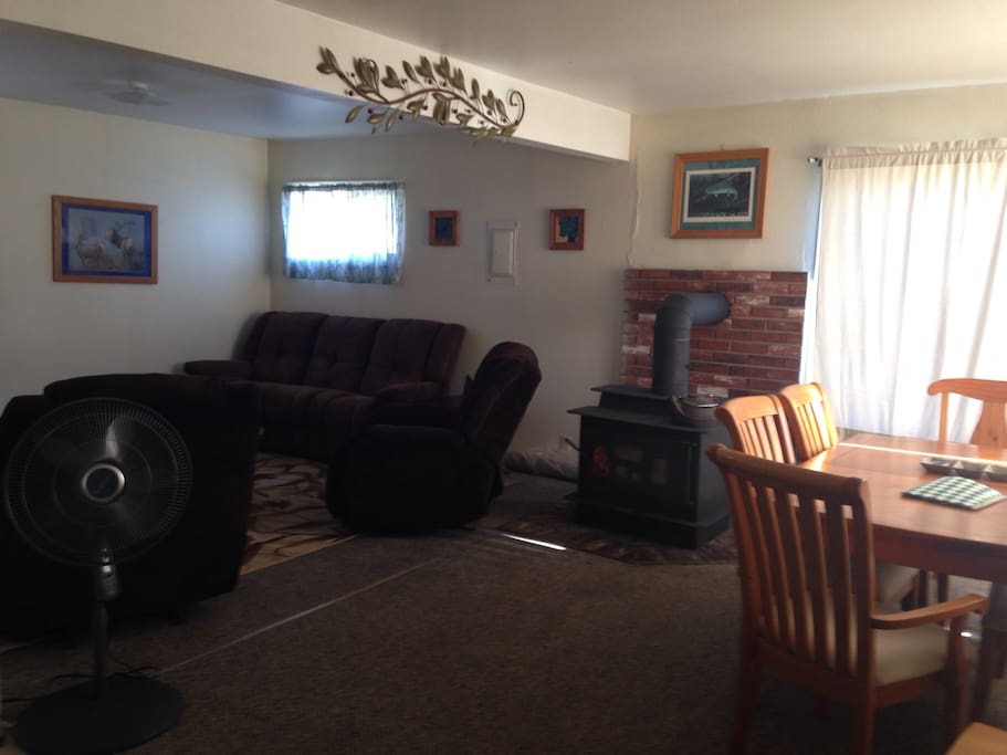 Spacious living room features DVD player/TV, reclining sofa and two comfy lazy boy chairs.