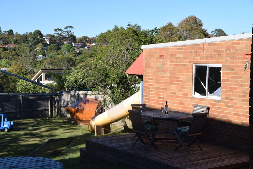 Safe backyard with deck and cubby house.