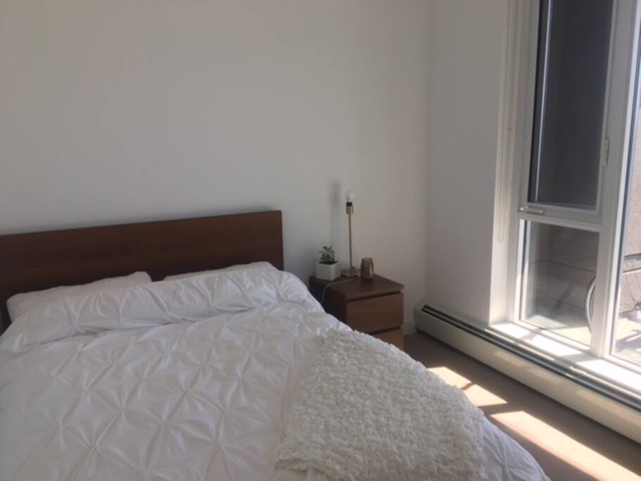 small bedroom with double bed and large window to patio (beautiful view)