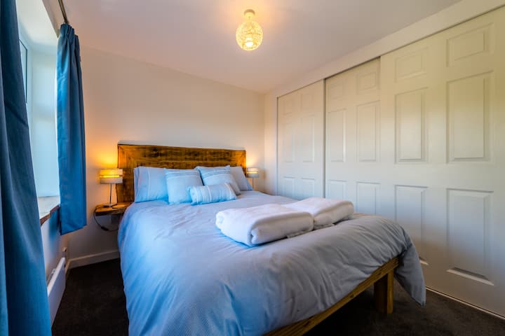 Pretty double bedroom with handmade larch headboard