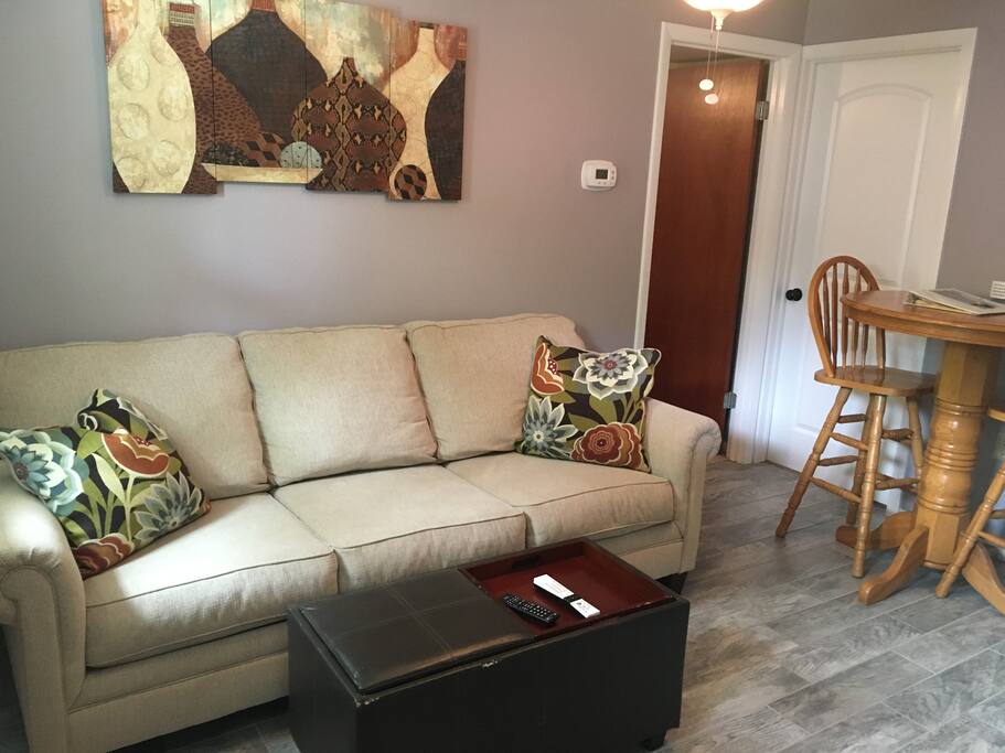 The living room and dining area are cozy and comfortable. The apartment does connect to the rest of our home through the white door, which will remain locked during your stay for complete privacy.