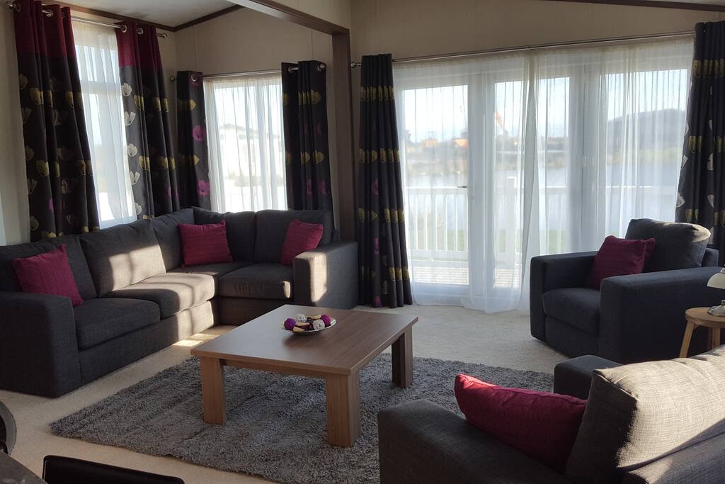 Living room with entrance to decking with stunning views
