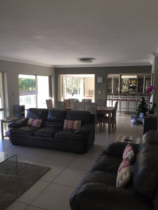 Downstairs living area, dining area at the back. Room has sea view.