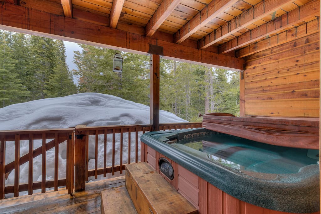 The lower-level patio features a sheltered hot tub that is perfect for all seasons.