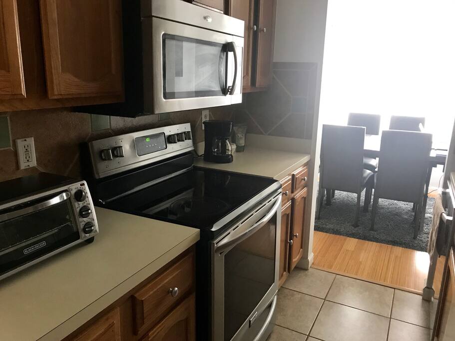 Full kitchen with basic utensils and a set of plates and cups