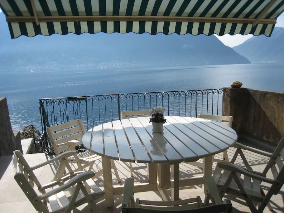 Casa Matteo features a gorgeous lakefront terrace which leads down to a grassed garden with direct water access via ladder to a shoreline jetty opposite the island of Isola Comacina