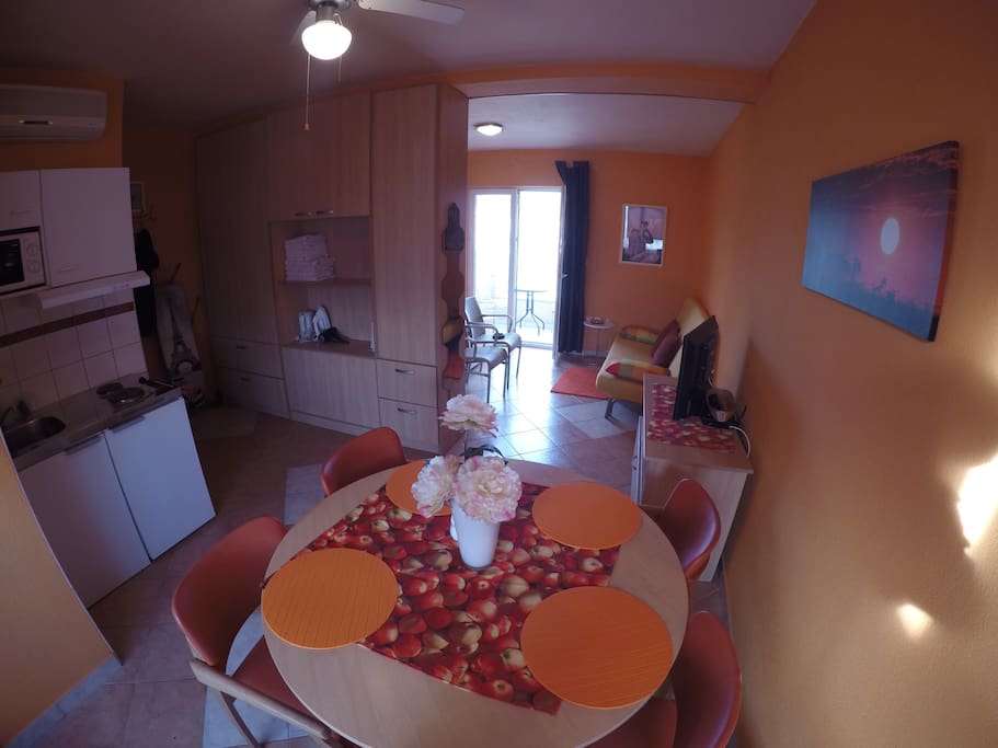 Nice and sweet living room with small kitchen with everything you need for preparing a nice meal.
