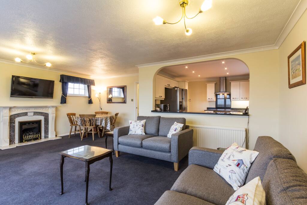 Large lounge with table and chairs and 40" wall mounted TV with Freeview