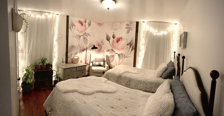 Bedroom #2 features two twin beds that can be pushed together for a second King-sized bed. This room receives tons of natural light and features warm oak hardwood floors and a large mural framed with vintage barn wood.