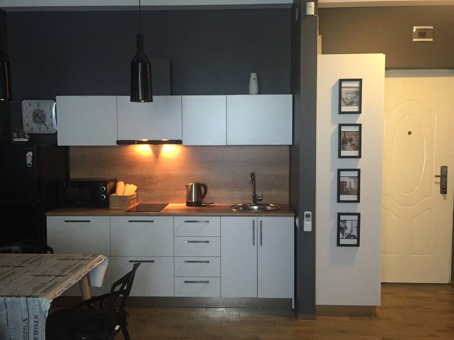 Main studio room is equipped with a lovely kitchen and dining area.