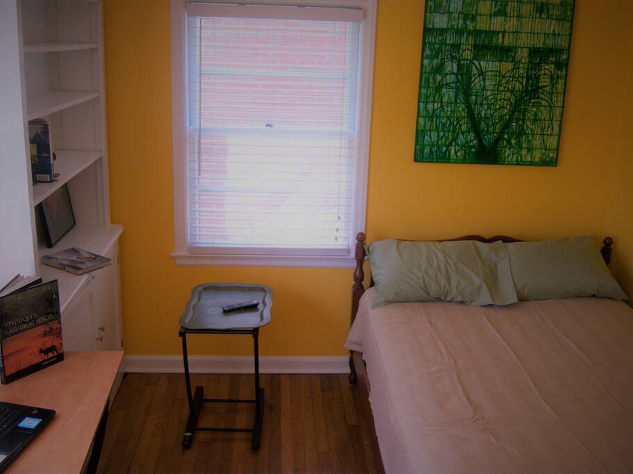 The private bedroom has a queen sized bed and plenty of shelves.