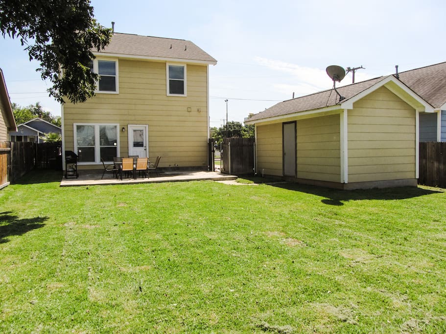 Oversized backyard for downtown area includes stainless steel grill and seating area
