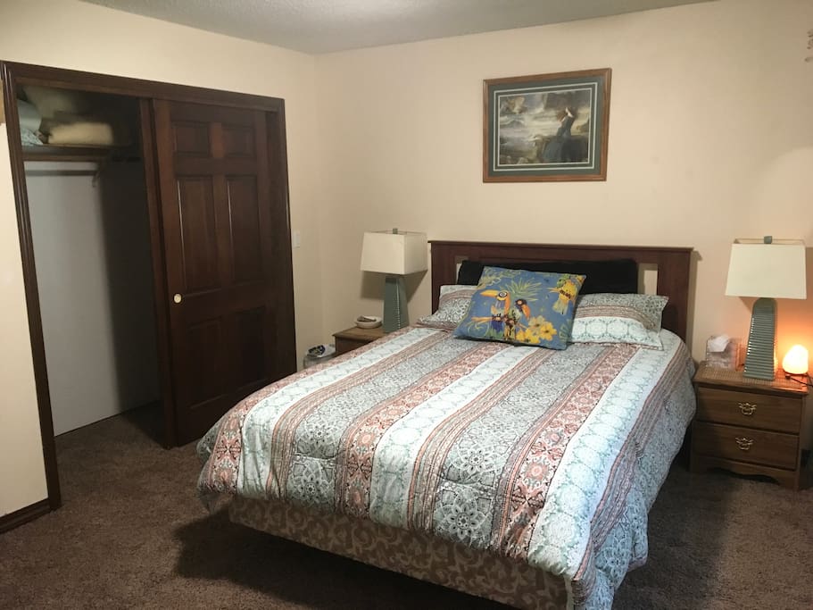Full master bedroom with queen bed and large double closet.