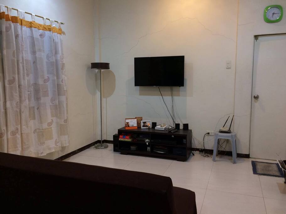 there is a couch and a television with cable