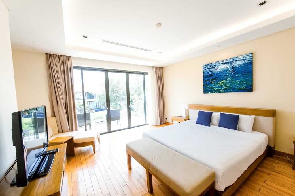 Bedroom # 1 on the second floor. Spacious oasis, with balcony to view the garden space in the back.