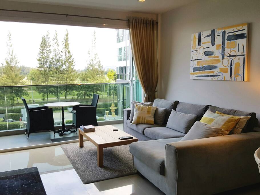 Bright open lounge with views out to the golf course and beach beyond.