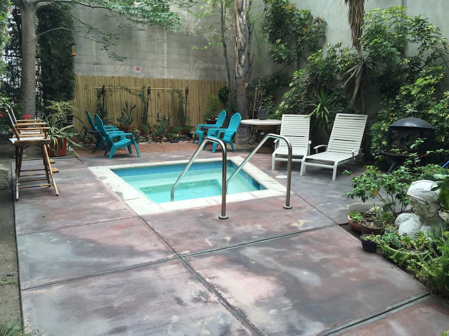 This is the community jacuzzi area with lounge chairs and garden area for building which is steps from my loft space.