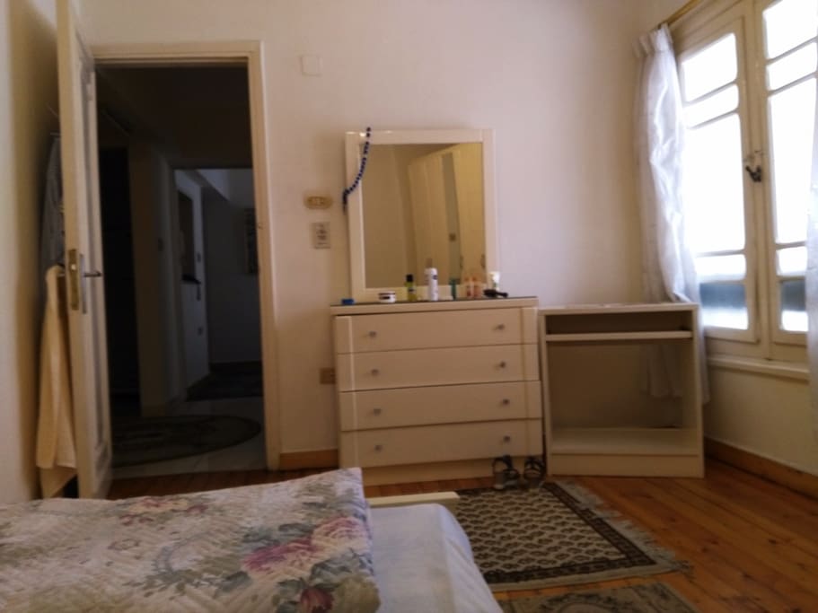 Main bedroom for two persons. Double size bed, wardrobe, night table, dresser with mirror and an air conditioner