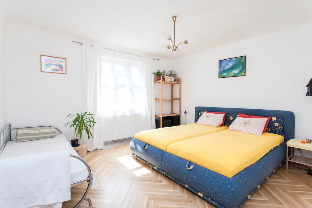 The bedroom with comfortable double bed and sofa.