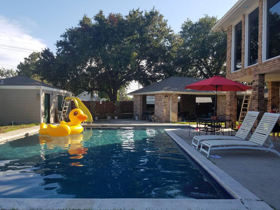 pool and gazebo in the distance with pool house to the left