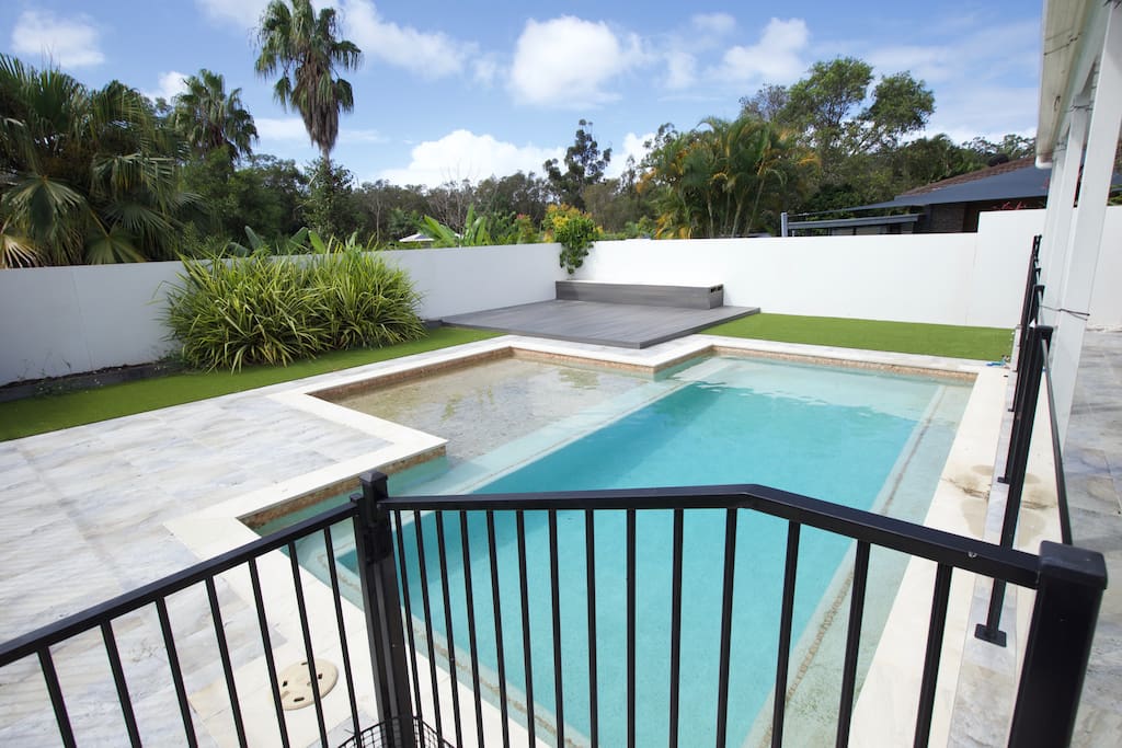 Beach entry pool with large deck and grassed area