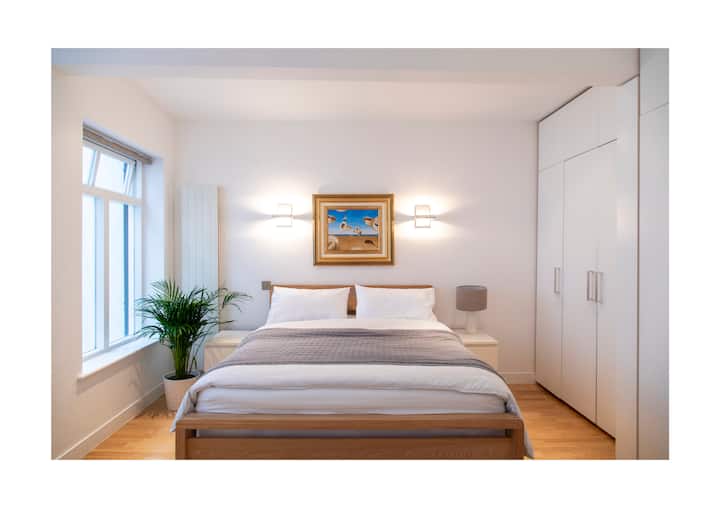 主卧「双人高」天花板和白色公司的豪华床上用品。配备Netflix和Prime的高清电视