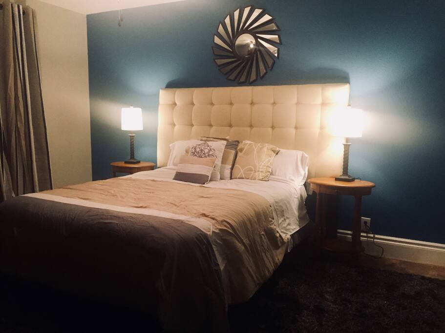 Master bedroom with ceiling fan and plush queen size bed