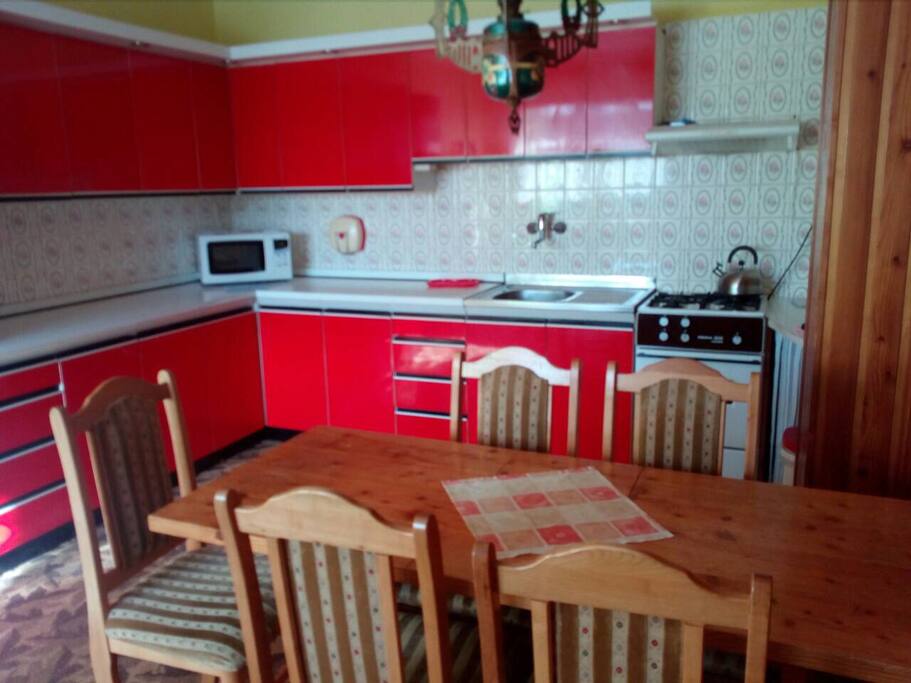 Kitchen with stove, fridge, microwave.