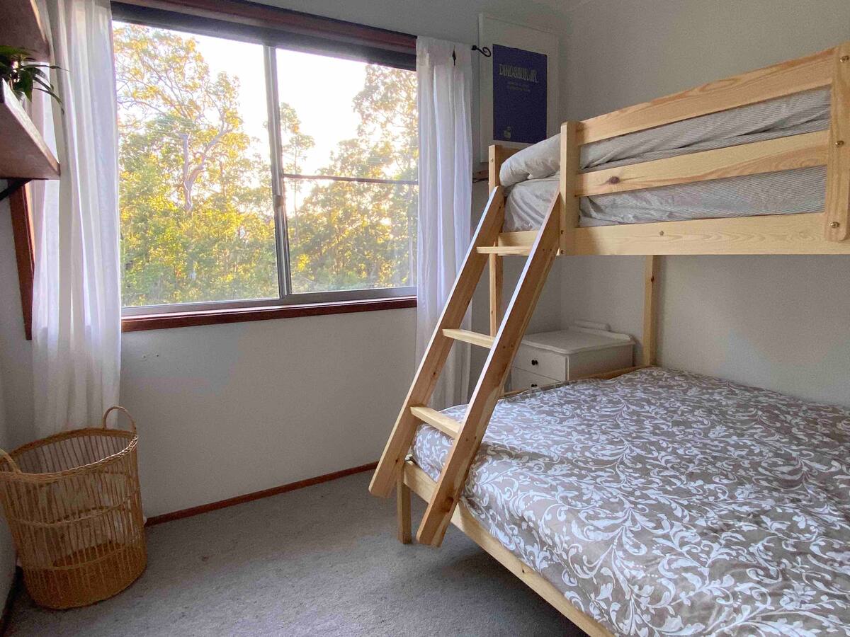 Timber bunk bed with a double bottom bunk and single top bunk