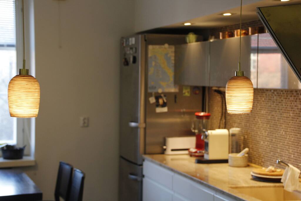 There are one large dining table and a bar table in the kitchen