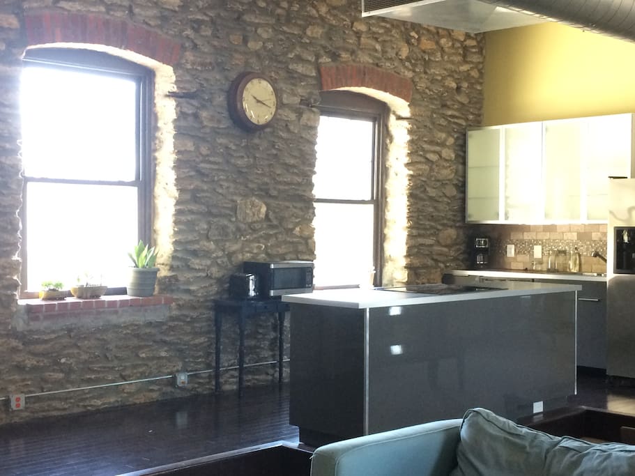 Exposed stone wall on one entire length