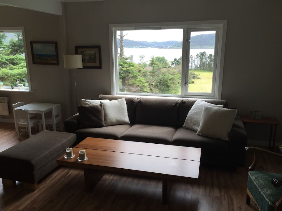 Very comfy sofa in spacious living/dining room with great views from all windows